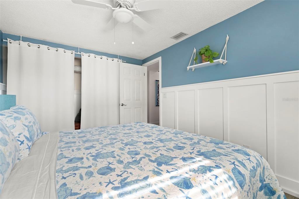 14030 79th Avenue Seminole, FL 33776 - Photo 22 of 33 a bedroom with a bed and a chandelier