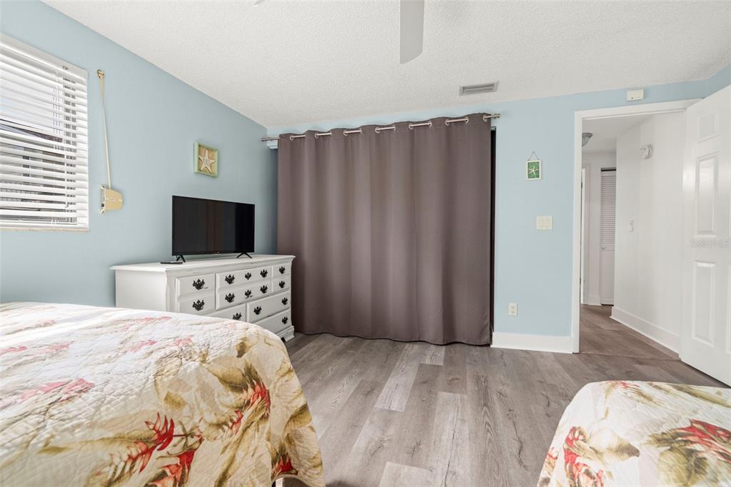 14030 79th Avenue Seminole, FL 33776 - Photo 25 of 33 a bedroom with a bed and a flat screen tv