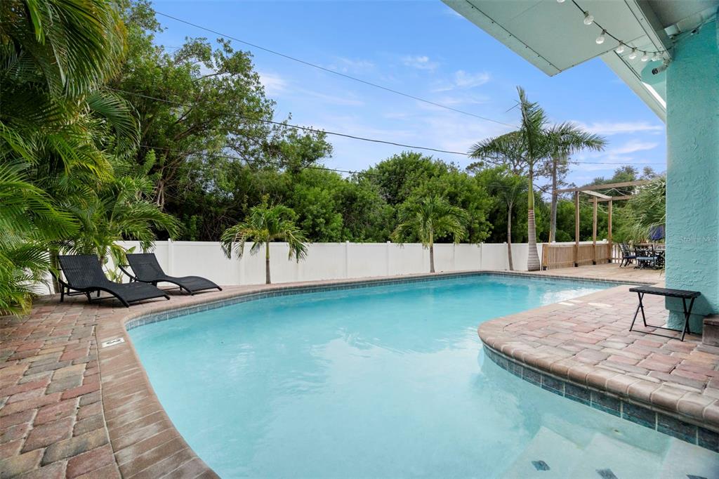 14030 79th Avenue Seminole, FL 33776 - Photo 27 of 33 a view of a swimming pool with a patio