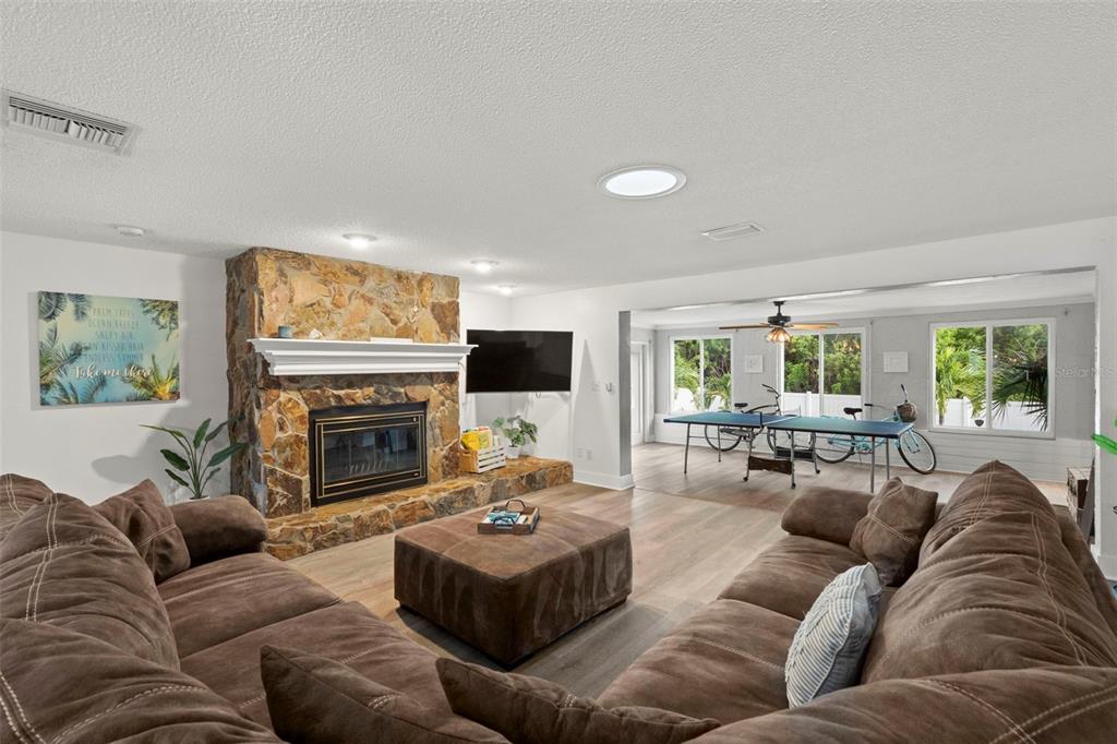 14030 79th Avenue Seminole, FL 33776 - Photo 7 of 33 a living room with furniture a fireplace and a flat screen tv