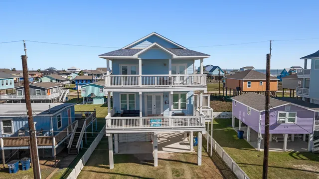 an aerial view of multiple houses with a city