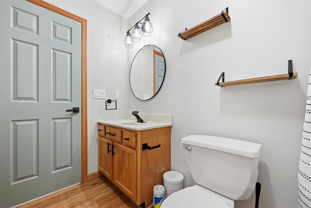 387 Blue Ridge Road Saylorsburg, PA 18353 - Photo 71 of 90 A well-appointed lavatory presents a wooden vanity, complemented by a round mirror and overhead modern lighting.