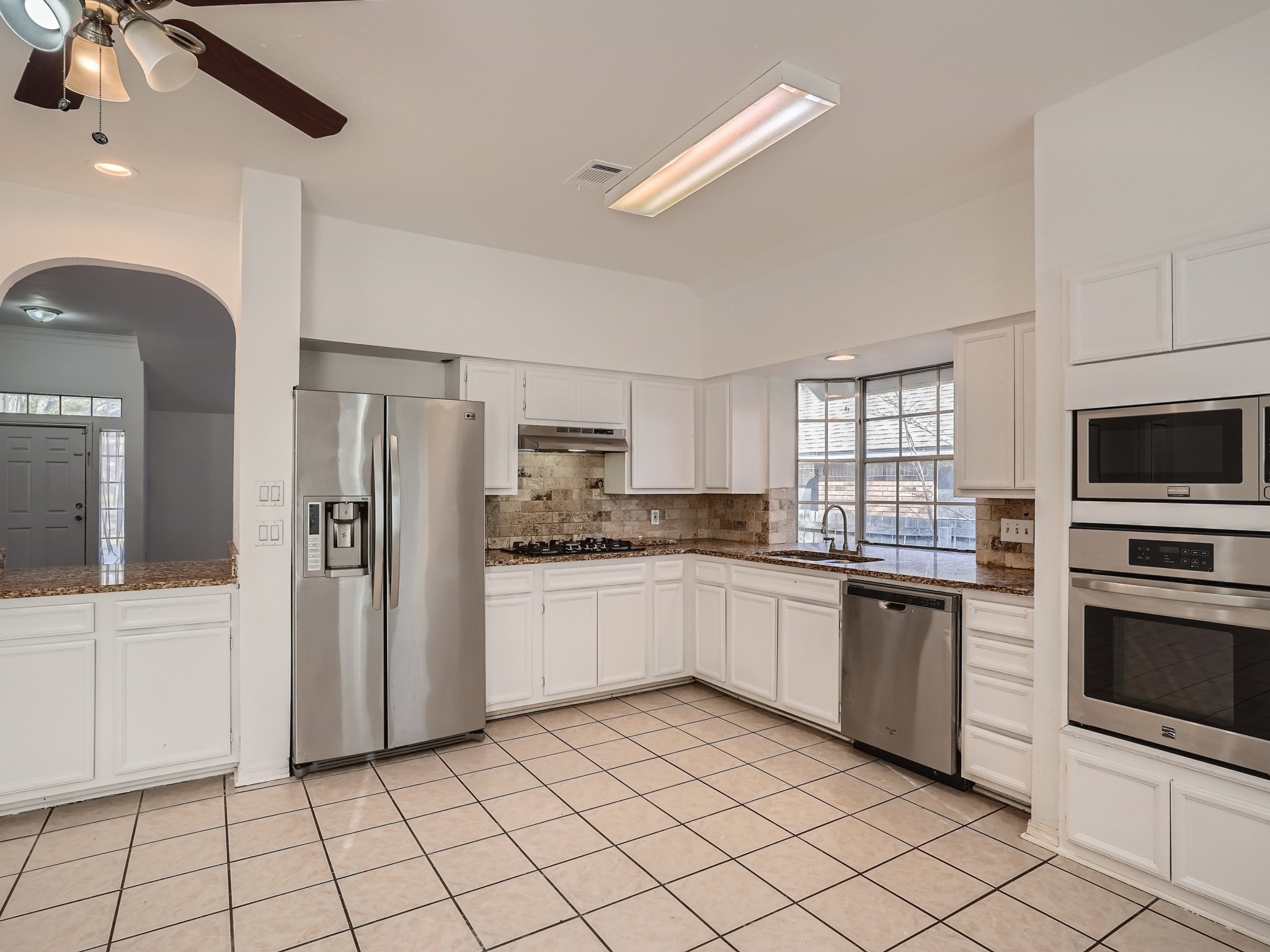 811 Canyon Bend Road Pflugerville, TX 78660 - Photo 4 of 11 a kitchen with stainless steel appliances granite countertop a refrigerator and a sink