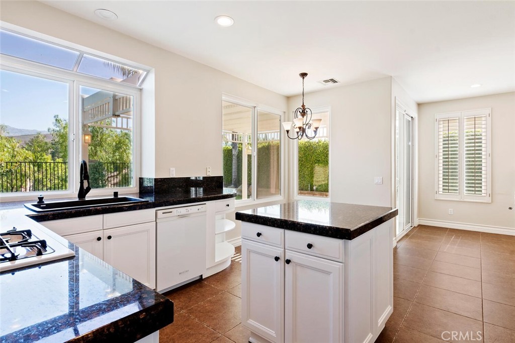5149 Pesto Way Oak Park, CA 91377 - Photo 14 of 42 a kitchen with stainless steel appliances a sink a stove and a window
