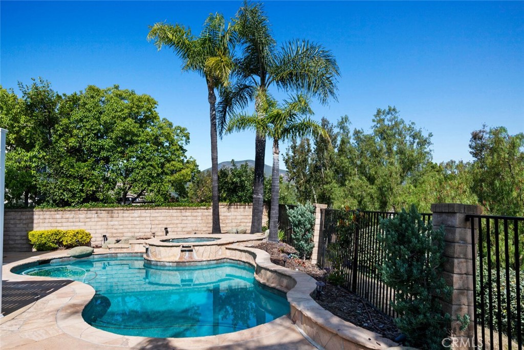 5149 Pesto Way Oak Park, CA 91377 - Photo 18 of 42 a view of a swimming pool with a patio