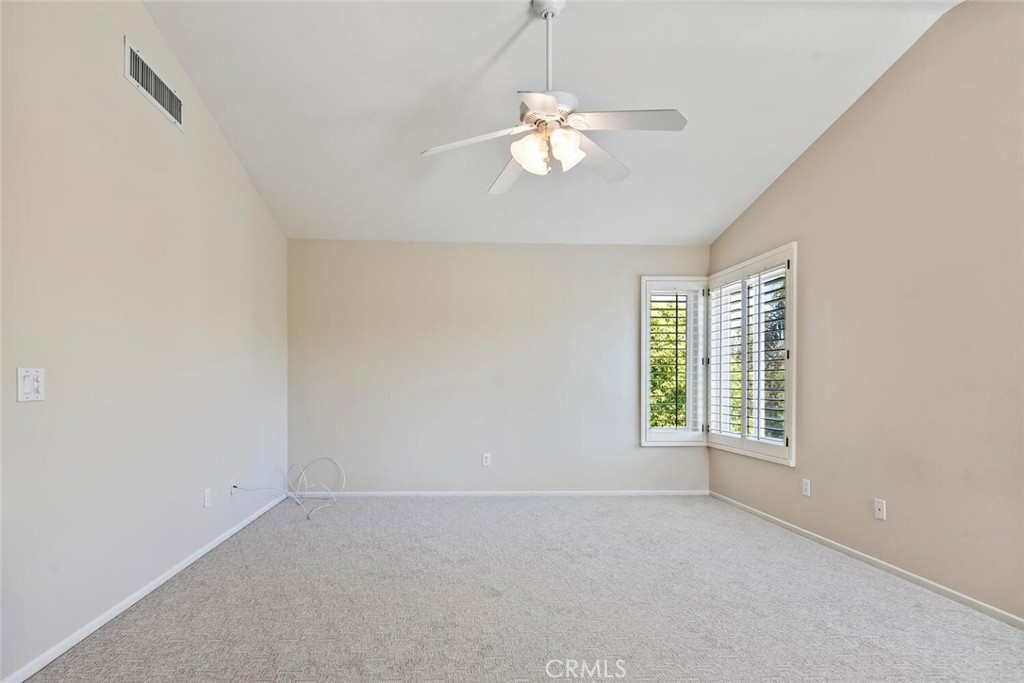 5149 Pesto Way Oak Park, CA 91377 - Photo 26 of 42 an empty room with windows and chandelier fan