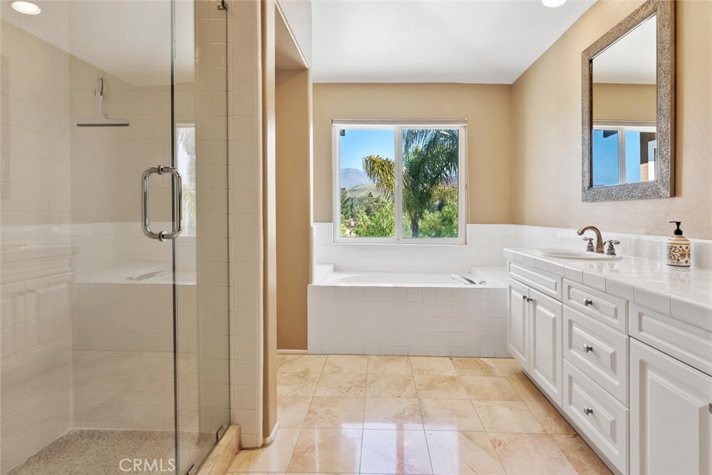 5149 Pesto Way Oak Park, CA 91377 - Photo 28 of 42 a bathroom with a tub sink and mirror