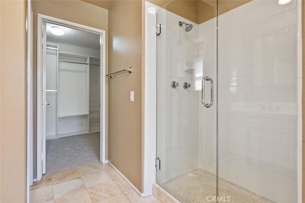 5149 Pesto Way Oak Park, CA 91377 - Photo 30 of 42 a bathroom with a shower and a glass door