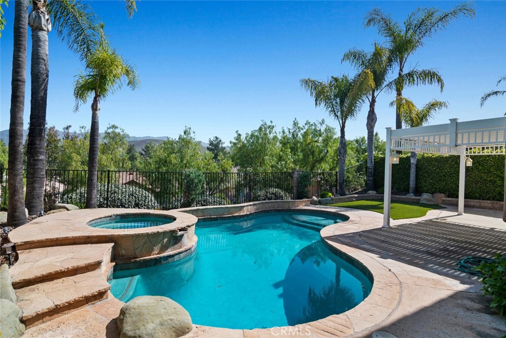 5149 Pesto Way Oak Park, CA 91377 - Photo 3 of 42 a view of a swimming pool with a patio
