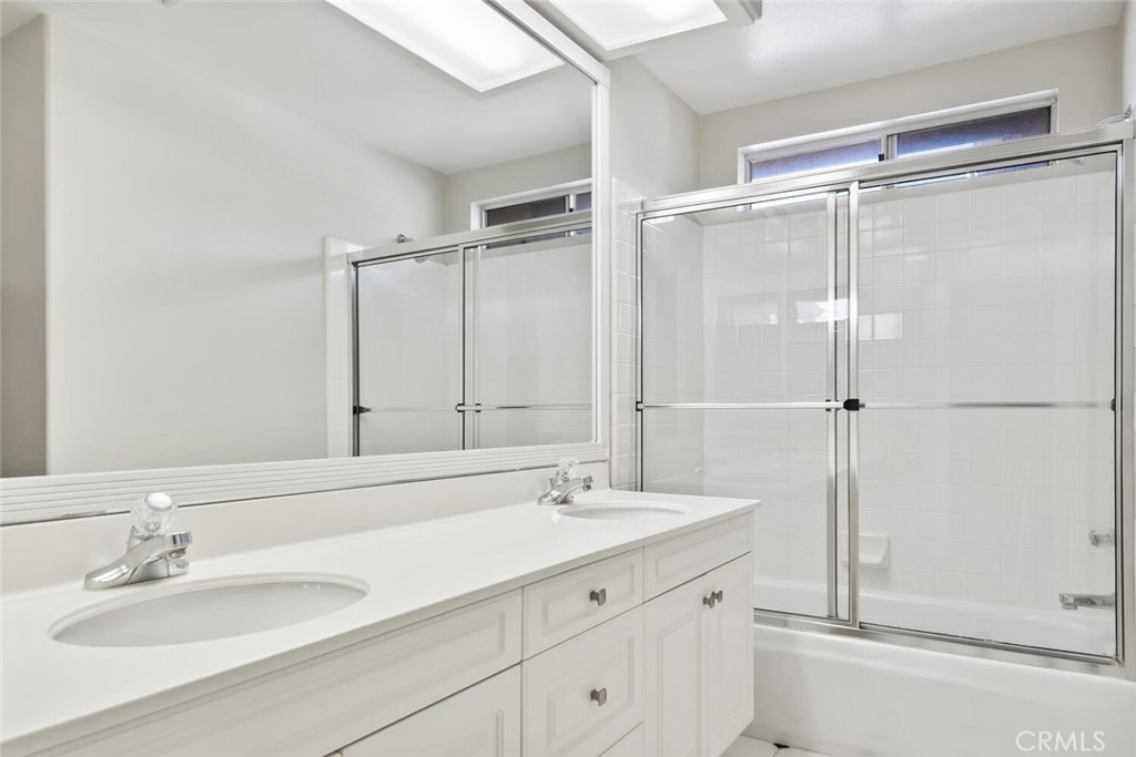 5149 Pesto Way Oak Park, CA 91377 - Photo 36 of 42 a bathroom with a shower sink and mirror
