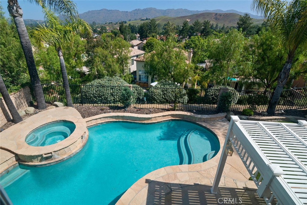 5149 Pesto Way Oak Park, CA 91377 - Photo 4 of 42 a view of a swimming pool with a patio