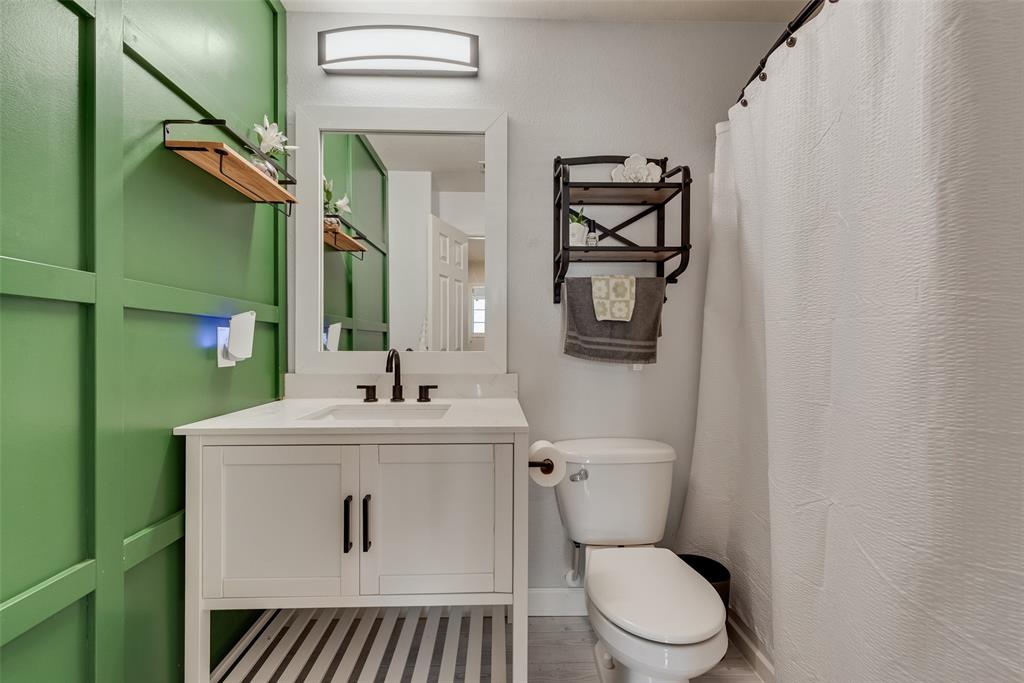 149 Cattlemans Creek Road Newark, TX 76071 - Photo 21 of 39 Hall bathroom with board and batten decorative wall and ceramic tile floors at 149 Cattlemans Creek Rd in the Chisholm Springs neighborhood in Newark, TX 76071