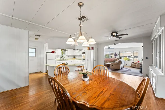 a view of a dining room with furniture wooden floor and chandelier