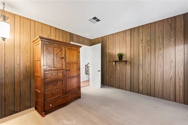 a view of an empty room with wooden walls