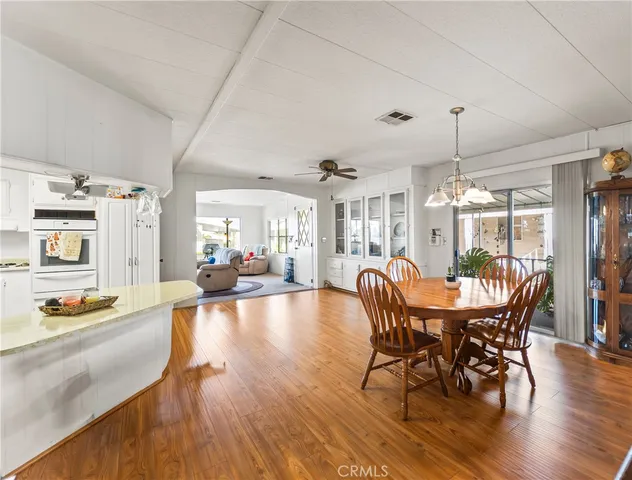 a dining room with furniture window and wooden floor