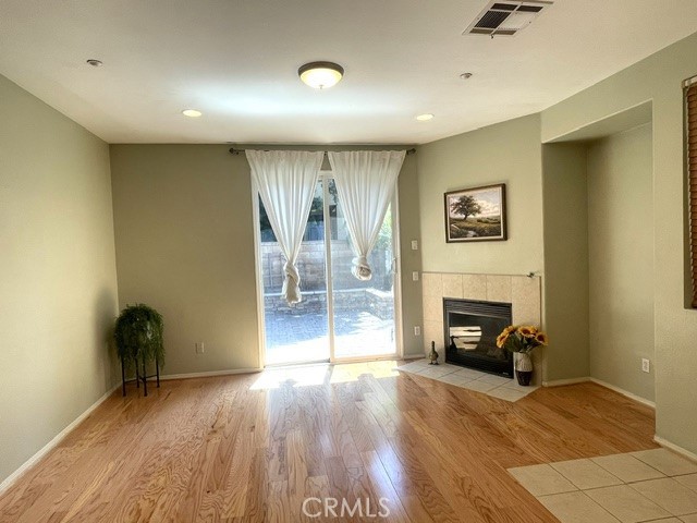 8692 East 9th Street, Unit 56 Rancho Cucamonga, CA 91730 - Photo 9 of 34 a view of an empty room with a fireplace and a window