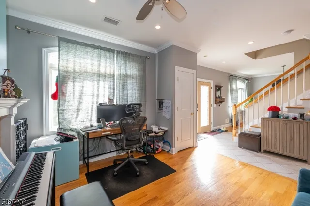 a view of a livingroom with workspace and a window