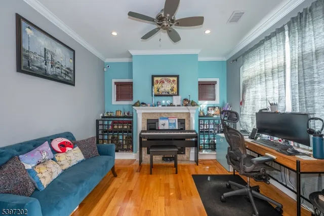 a living room with furniture a piano and a flat screen tv