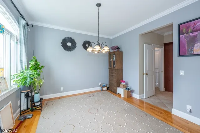 a dining room with chandelier fan and a chandelier
