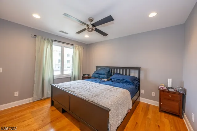 a bed room with a bed and a ceiling fan