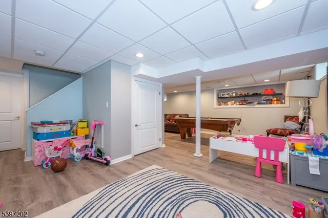 a bedroom with furniture and a wooden floor