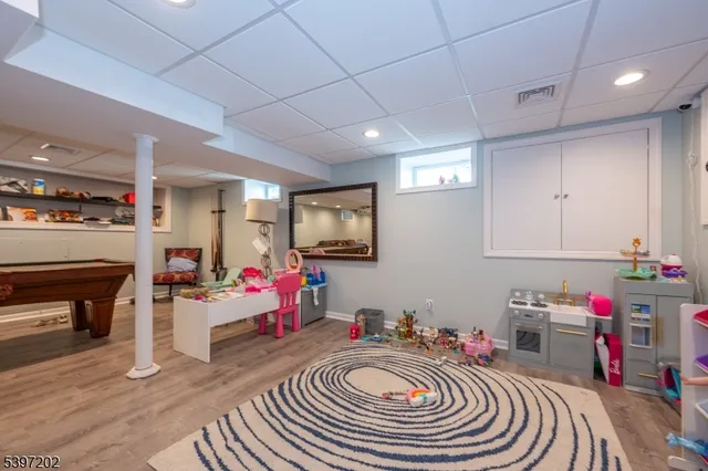 a room with furniture a fireplace and gym equipment