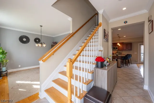 a view of a hallway with dining room and chandelier