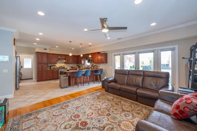 a living room with furniture and kitchen view