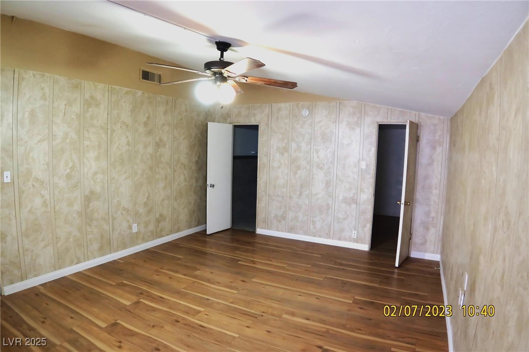 10 East Bonanza Road Las Vegas, NV 89101 - Photo 23 of 35 Unfurnished room featuring ceiling fan, lofted ceiling, hardwood / wood-style floors, and visible vents