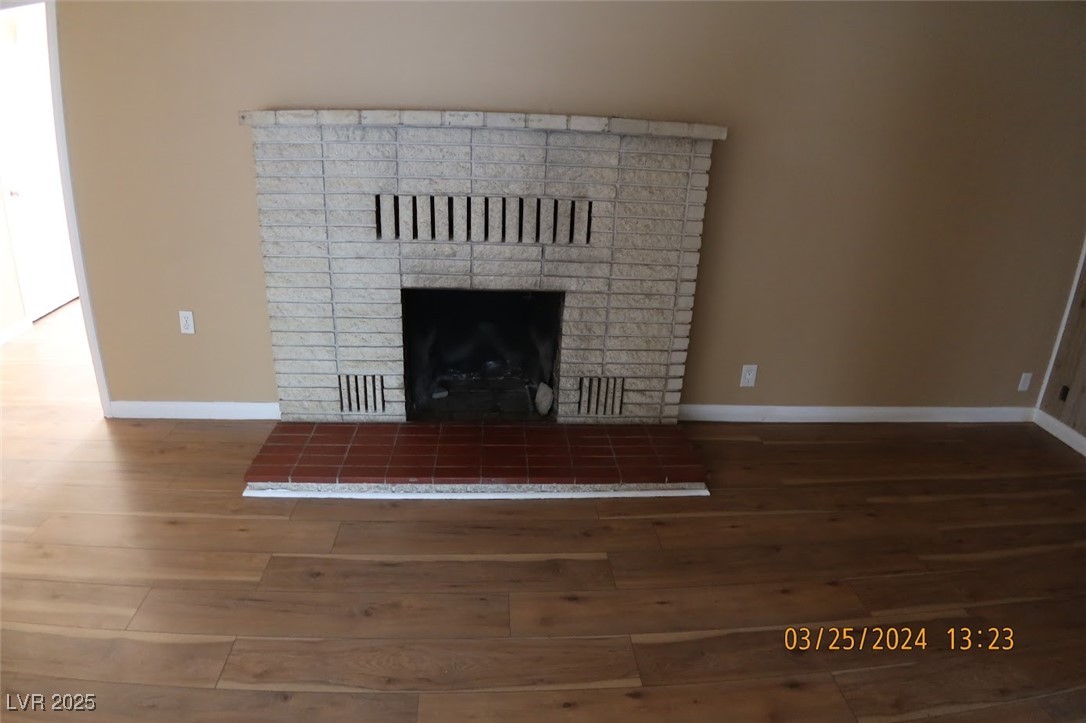 10 East Bonanza Road Las Vegas, NV 89101 - Photo 5 of 35 Interior details featuring baseboards, a brick fireplace, and wood finished floors
