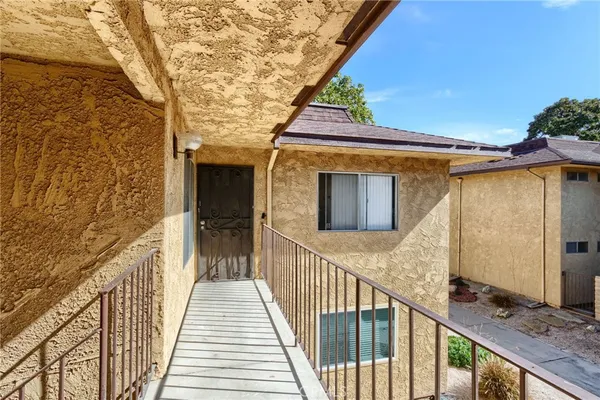a view of a balcony with wooden floor and staircase