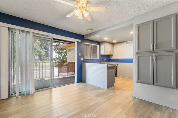 a view of a kitchen with wooden cabinet and a window