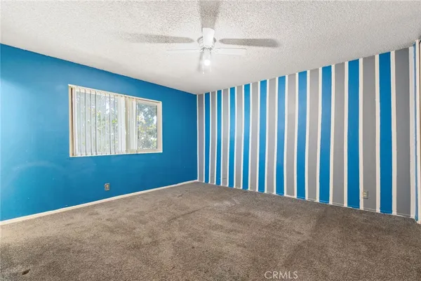 a view of a livingroom with a ceiling fan and window