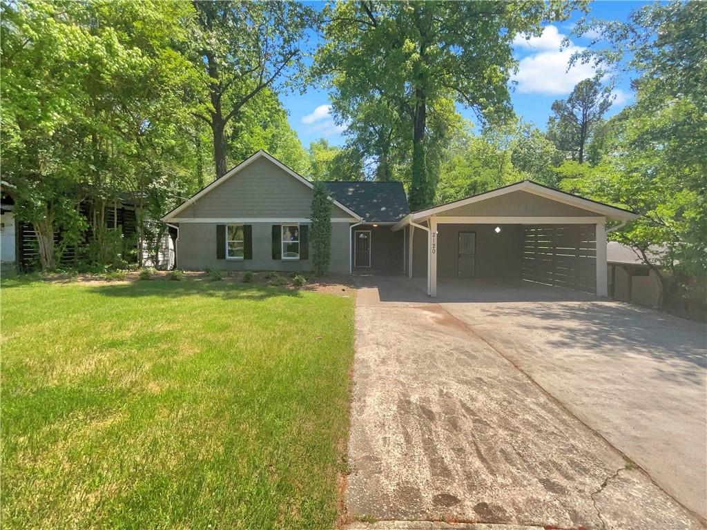 2120 Drew Valley Road Northeast Atlanta, GA 30319 - Photo 1 of 1 a front view of a house with a garden and trees