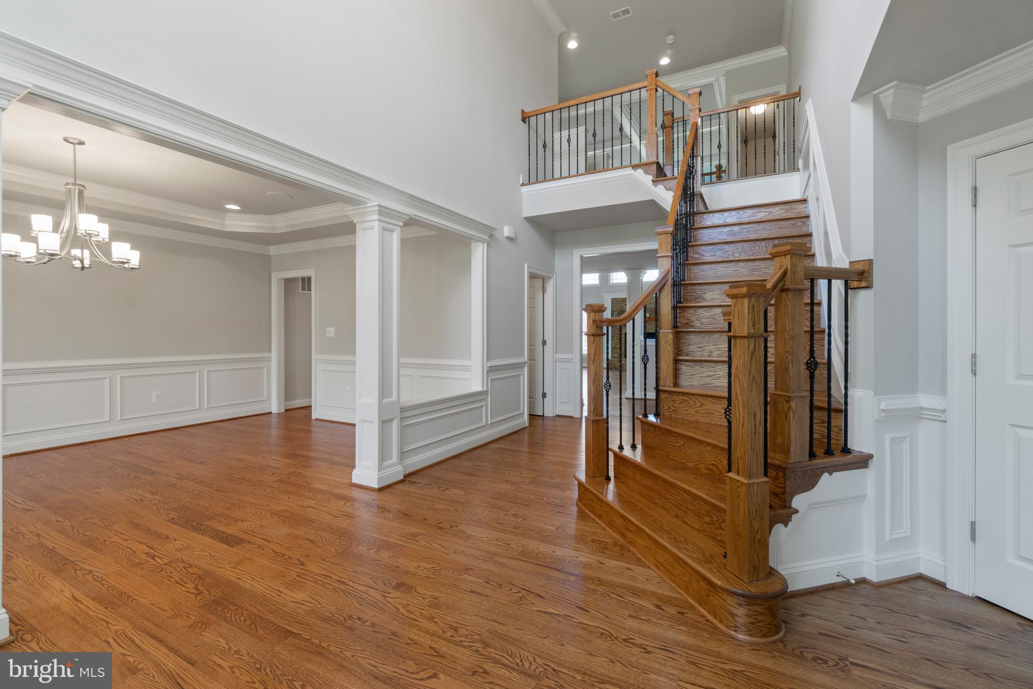 13725 Orlando Road Nokesville, VA 20181 - Photo 11 of 65 a view of a hallway with wooden floor and staircase