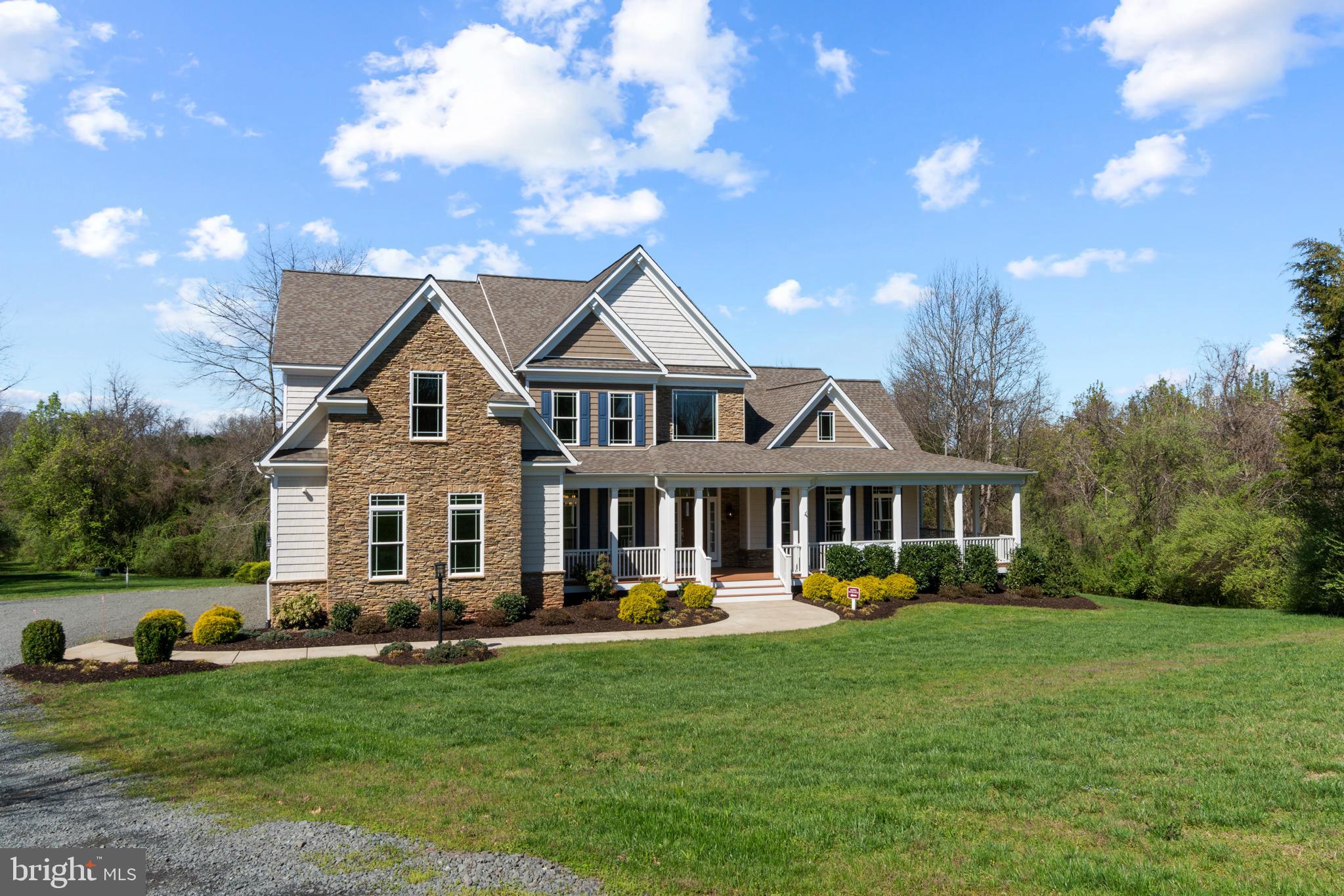 13725 Orlando Road Nokesville, VA 20181 - Photo 2 of 65 a front view of a house with garden and trees