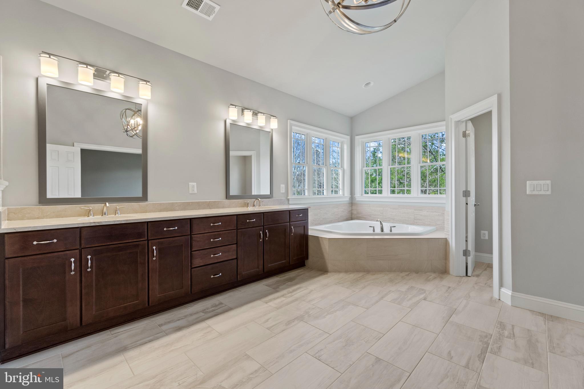 13725 Orlando Road Nokesville, VA 20181 - Photo 38 of 65 a spacious bathroom with a tub sink and mirror