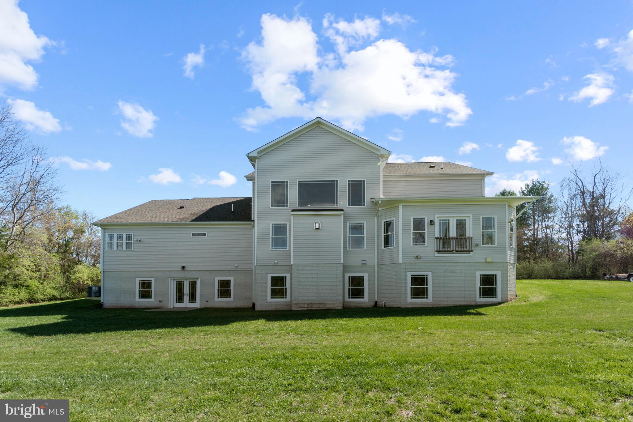 13725 Orlando Road Nokesville, VA 20181 - Photo 65 of 65 a view of a big house with a big yard and large trees