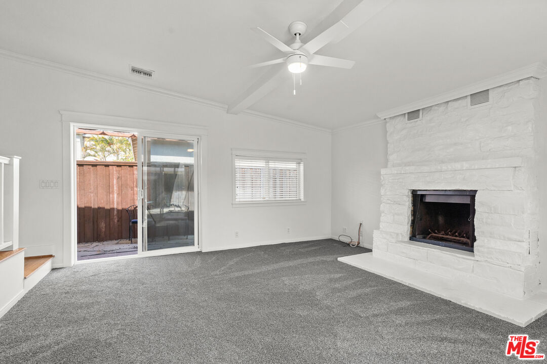 4352 Globe Avenue Culver City, CA 90230 - Photo 12 of 30 a view of an empty room with a fireplace and a window