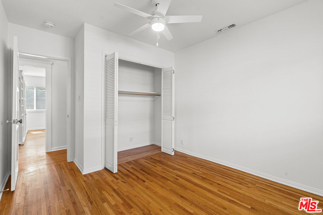 4352 Globe Avenue Culver City, CA 90230 - Photo 22 of 30 a view of a room with wooden floor and a ceiling fan