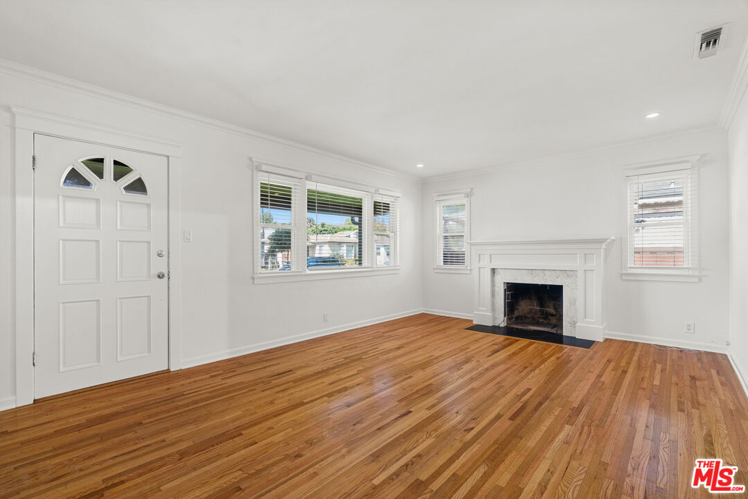 4352 Globe Avenue Culver City, CA 90230 - Photo 3 of 30 a view of empty room with wooden floor and fireplace