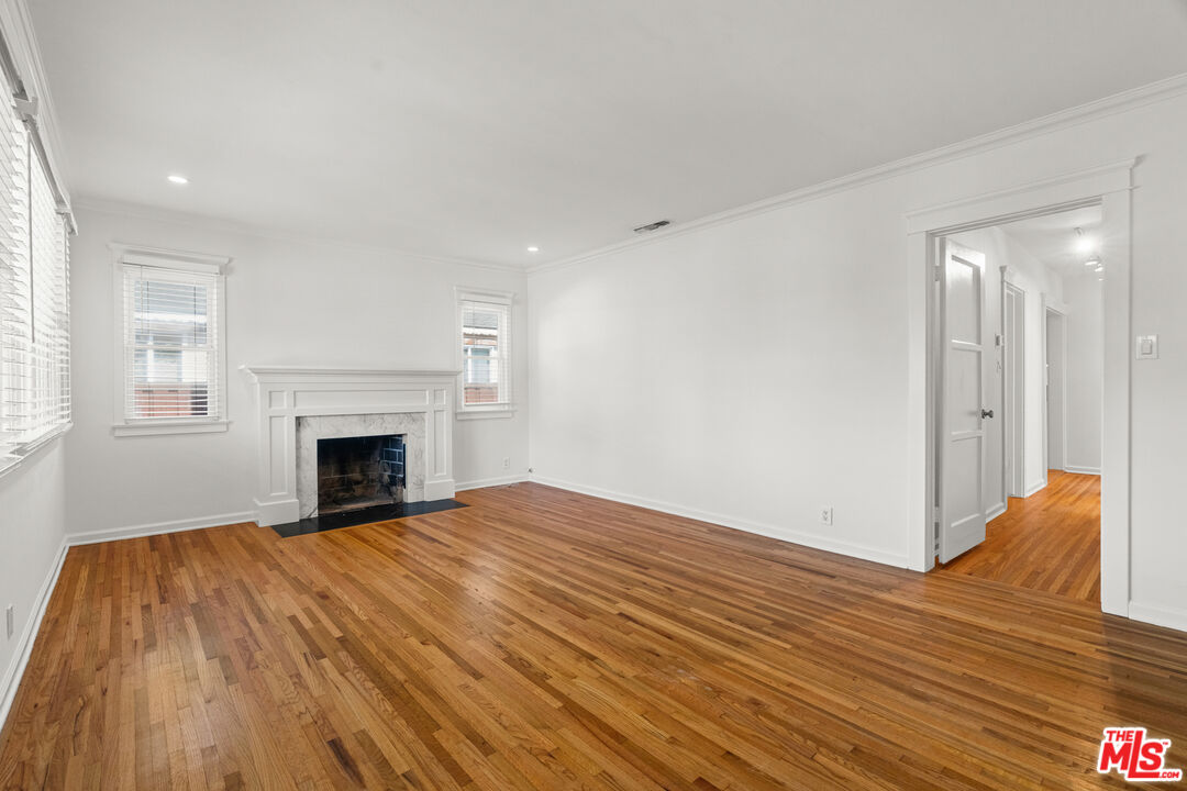 4352 Globe Avenue Culver City, CA 90230 - Photo 5 of 30 a view of empty room with wooden floor and fireplace