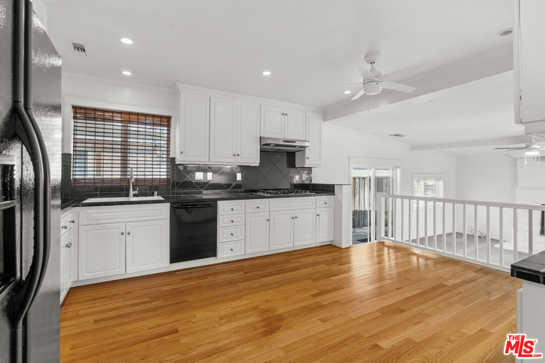4352 Globe Avenue Culver City, CA 90230 - Photo 6 of 30 a kitchen with granite countertop a sink stainless steel appliances and cabinets