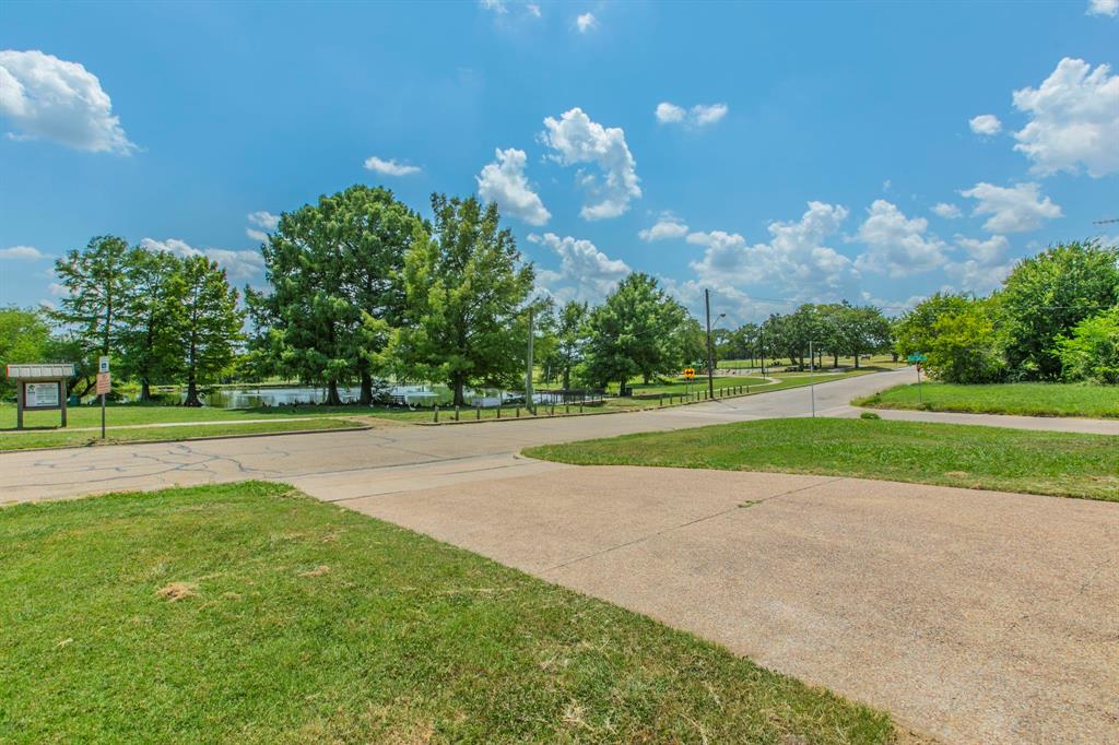 1936 Post Oak Drive Waco, TX 76705 - Photo 22 of 33 View of community with a lawn, curved driveway, and a water view