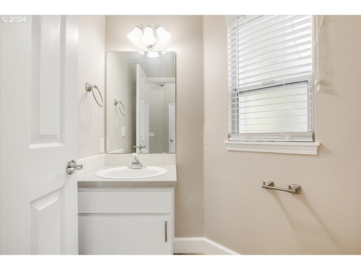 10570 Southwest Windsor Court Portland, OR 97223 - Photo 20 of 35 a bathroom with a sink vanity and a mirror