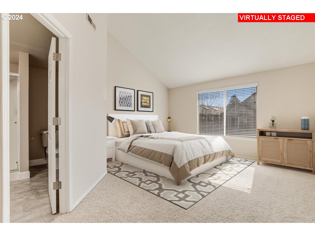 10570 Southwest Windsor Court Portland, OR 97223 - Photo 23 of 35 a spacious bedroom with a bed a couch and window