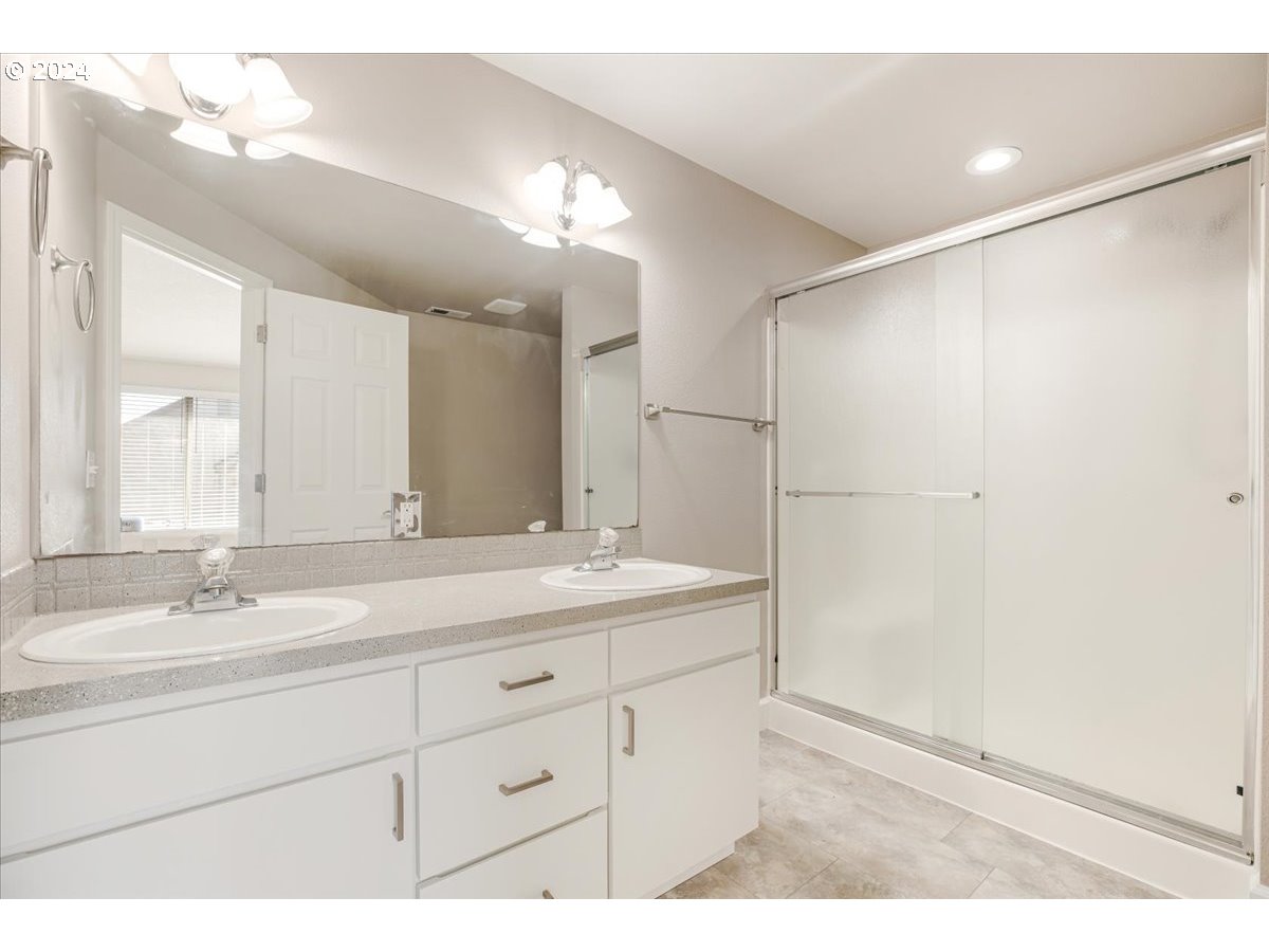 10570 Southwest Windsor Court Portland, OR 97223 - Photo 27 of 35 a bathroom with a sink double vanity and a mirror