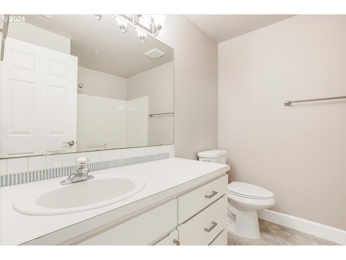 10570 Southwest Windsor Court Portland, OR 97223 - Photo 30 of 35 a bathroom with a sink a toilet and a mirror