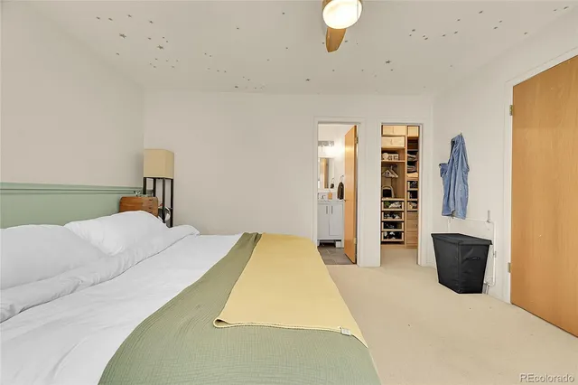 a kitchen with stainless steel appliances granite countertop a stove top oven a sink a dining table and chairs with wooden floor