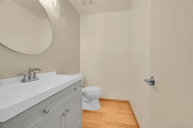 a view of a house with a large tree and a yard